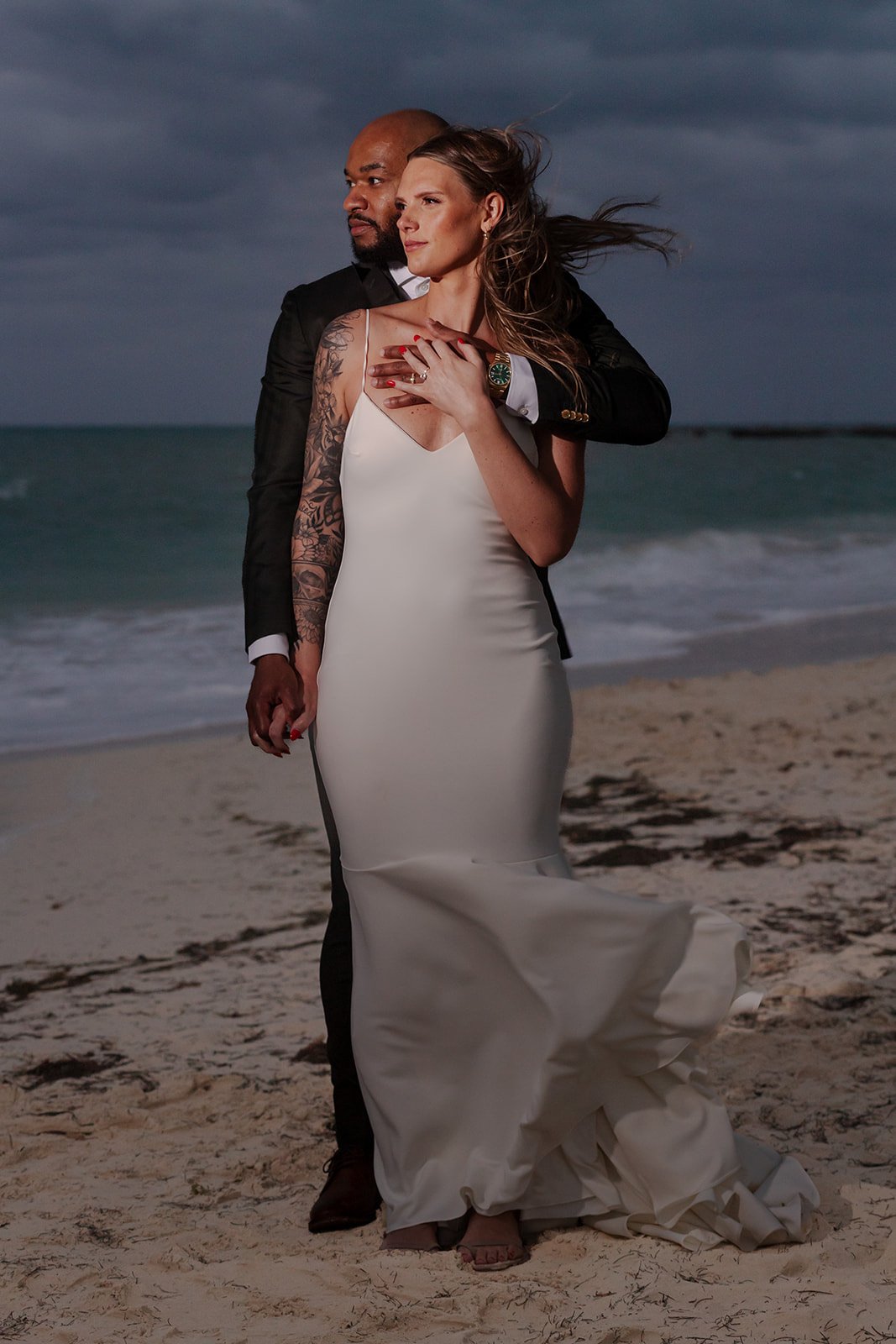 Couple posing together on the beach after their mexico ceremony at Secrets Playa Mujeres